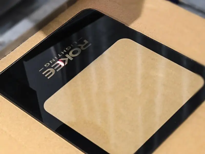 ROKEE Lighting logo on an LED luminaire glass panel